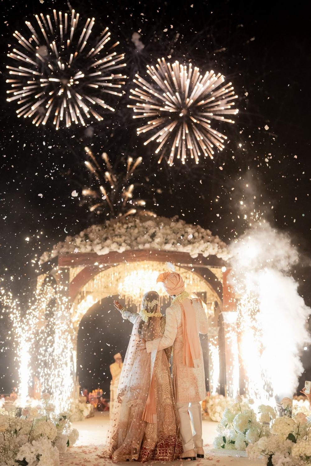 Fireworks above a floral arch